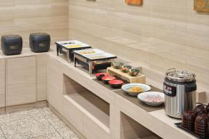a buffet in a hotel room with food on a counter at Villa Fontaine Tokyo Nihombashi Hakozaki in Tokyo