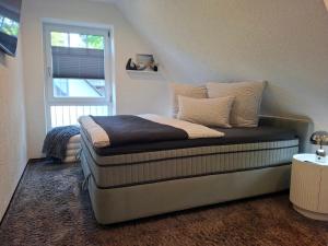 a bed sitting in a room with a window at Ferienhaus Strandnah - Ostseeurlaub in Glowe in Top-Lage in Glowe