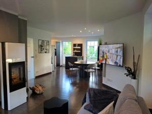 a living room with a couch and a table at Ferienhaus Strandnah - Ostseeurlaub in Glowe in Top-Lage in Glowe