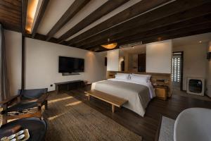 a bedroom with a large bed and a television at NINE PEAKS in Jiuzhaigou