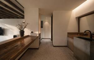 a bathroom with a sink and a counter with a vase at NINE PEAKS in Jiuzhaigou