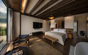 a bedroom with a large bed and a television at NINE PEAKS in Jiuzhaigou +26 photos