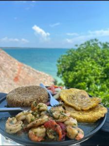 a plate of food with shrimp and toast on the beach at La Casa de la Tortuga in San Onofre