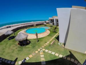 an aerial view of a resort with a swimming pool at Canoa Breeze - Beach Front in Canoa Quebrada