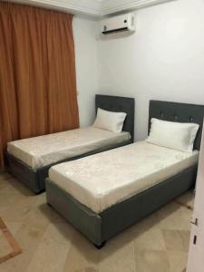 two beds sitting next to each other in a room at Bab bhar sousse in Sousse