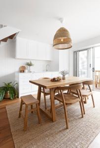 a dining room with a wooden table and chairs at Crystal Pacific Palm Beach in Gold Coast