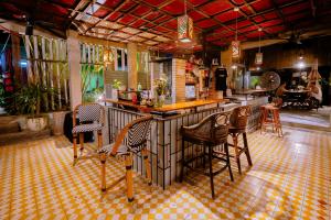 a bar in a restaurant with chairs and tables at Eia by Dawata Boutique Stay, Yoga & Cafe in Cebu City