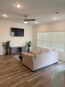 a living room with a couch and a flat screen tv at Modern Comfort in Morrow
