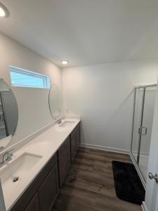 a bathroom with two sinks and a shower at Modern Comfort in Morrow +5 photos