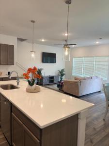 a kitchen and living room with a sink and a couch at Modern Comfort in Morrow