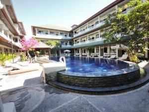 a pool in the courtyard of a hotel at Casa Mysa Hotel Kuta in Kuta