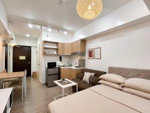 a living room with a couch and a table at Cozy Condo at Avida Tower 4, IT Park Cebu in Cebu City