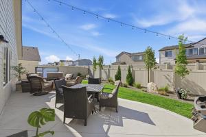a patio with a table and chairs and a fence at Mineral Spa Fire Pit Game Room Mini Split AC in Meridian