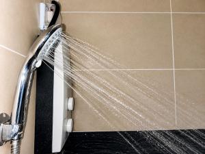 a shower with a shower curtain in a bathroom at MIGAs Haven at Sunvida Tower across SM City in Cebu City