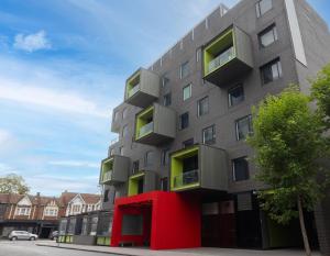 a tall building with a red building at Elli Prahran in Melbourne