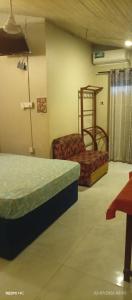 a room with two beds and a shelf in it at Sahansa hotel in Nugegoda