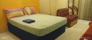 a bed and a chair in a room at Sahansa hotel in Nugegoda