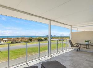 a view of the ocean from the balcony of a house at Ocean Views in Rockingham