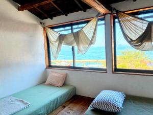 a room with two beds in a room with windows at Lemon tree hotel in Higashiura