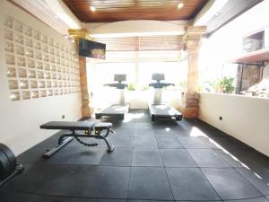a gym with three treadmills and a treadmill at Casa Mysa Hotel Kuta in Kuta