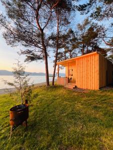a house on a hill with a grill in the grass at Sevan Resort No5 in Chʼkalovka