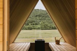 a window in a room with a view of a field at Otherland Hotel in Newfane +86 photos