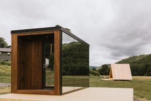 a glass house with a view of a field at Otherland Hotel in Newfane