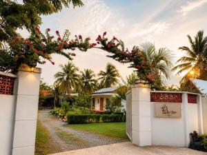 a gate to a house with flowers on it at Bụi Tre Homestay in Ben Tre