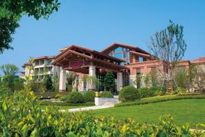 a building in a park with a green lawn at Crowne Plaza Huzhou by IHG in Huzhou