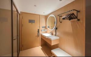 a bathroom with a sink and a mirror at JI Hotel Beijing Panjiayuan in Beijing