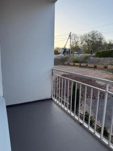 a room with a balcony with a view of a street at Квартира студия in Bosteri
