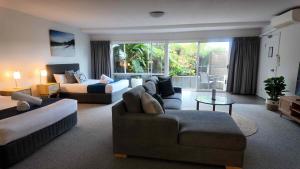 a living room with two couches and a couch at Albacore Apartments in Merimbula +55 photos