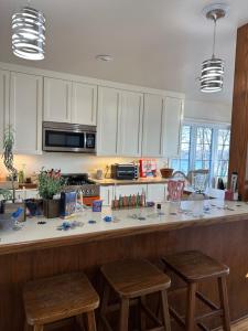 a kitchen with a counter with two stools at Lovely Lakeside Lodge in Canandaigua