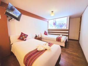 a hotel room with two beds and a window at Hotel Mirador All Sur in Cusco +17 photos