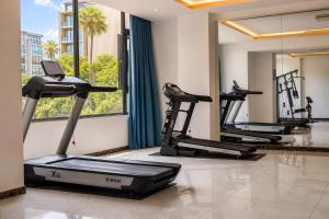 a row of treadmills in a fitness room with treadmillsktop at OCEAN HOTEL in Phnom Penh