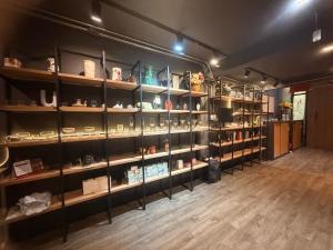 a room with shelves filled with lots of items at BANKBED Hostel in Bangkok