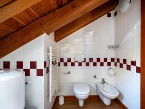 a bathroom with a toilet and a sink at Attic historic building with air conditioning in Ceresole Reale +32 photos