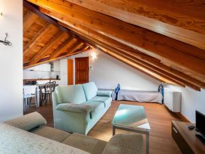 a living room with a couch and a table at Attic historic building with air conditioning in Ceresole Reale