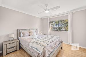 a bedroom with a large bed and a window at Sunrise Waters in Gorokan