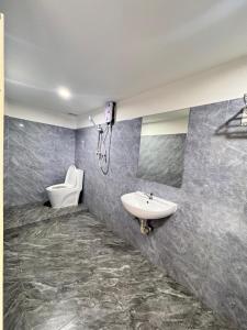 a bathroom with a sink and a toilet at Yula Hotel in Vientiane +18 photos