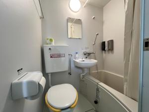 a bathroom with a toilet and a sink and a tub at ボウケンノモリささぐり in Sasaguri +34 photos
