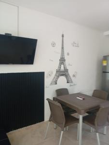 a dining room with a table and the eiffel tower at Tolu - Caribbean apartment in Santiago