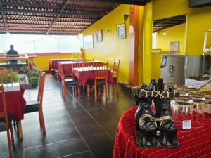 a dining room with tables and chairs and a restaurant at Hotel Mirador All Sur in Cusco