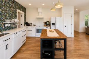 a kitchen with white cabinets and a wooden counter top at LeWeber Haus in Leavenworth