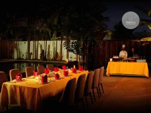 a table with red napkins and red candles on it at Tropical Garden House in Siem Reap +76 photos