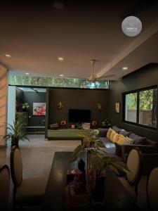 a living room with a couch and a tv at Tropical Garden House in Siem Reap