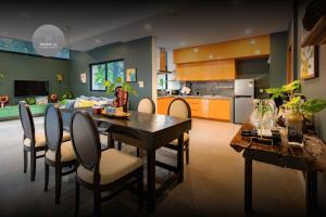 a kitchen and dining room with a table and chairs at Tropical Garden House in Siem Reap