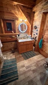 a bathroom with a sink in a wooden cabin at Chalet à Morillon in Morillon +22 photos