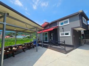 a group of picnic tables outside of a building at Twin Stay1 in Yonghwa