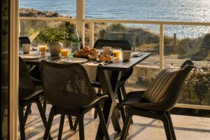 a table and chairs on a patio with a view of the ocean at Absolute Beachfront Escape Family Retreat in Mandurah